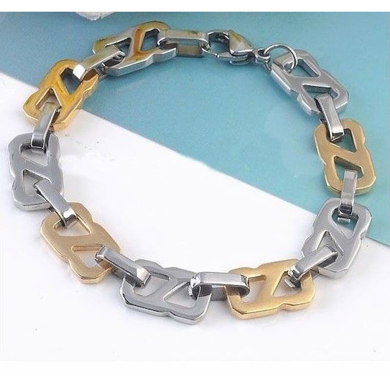 Brazalete robusto para hombre en acero inoxidable con diseño de eslabones bicolor en oro y plata pulida.
