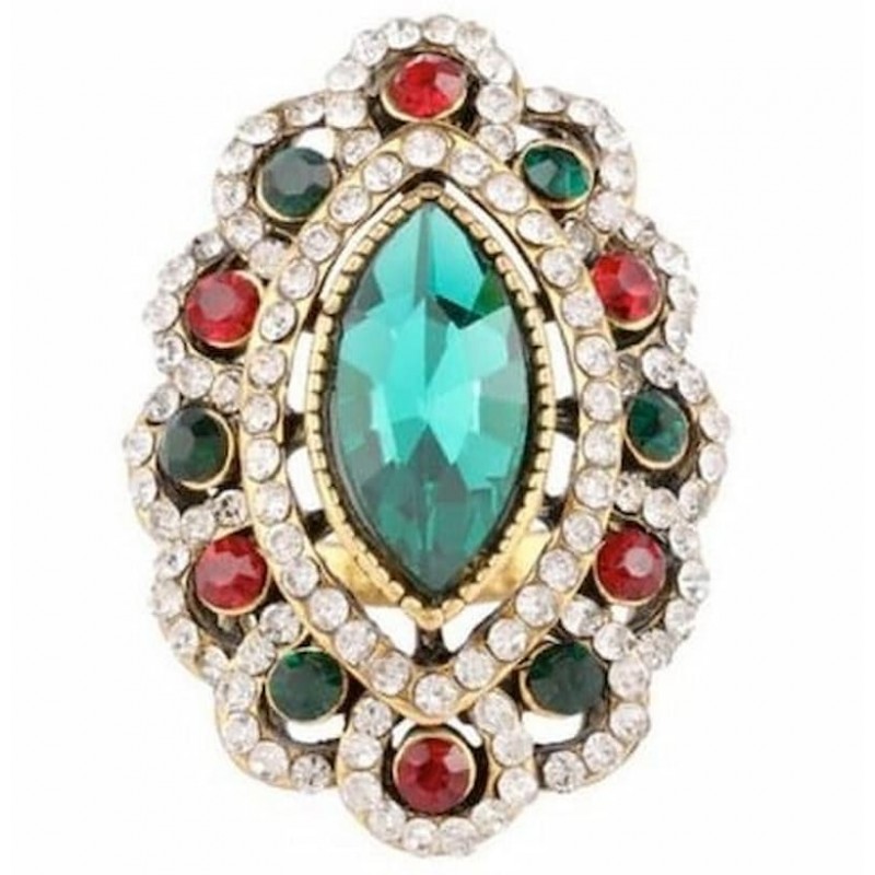 Anillo de acero acabado oro blanco con gran piedra central azul y orla de cristales multicolor.