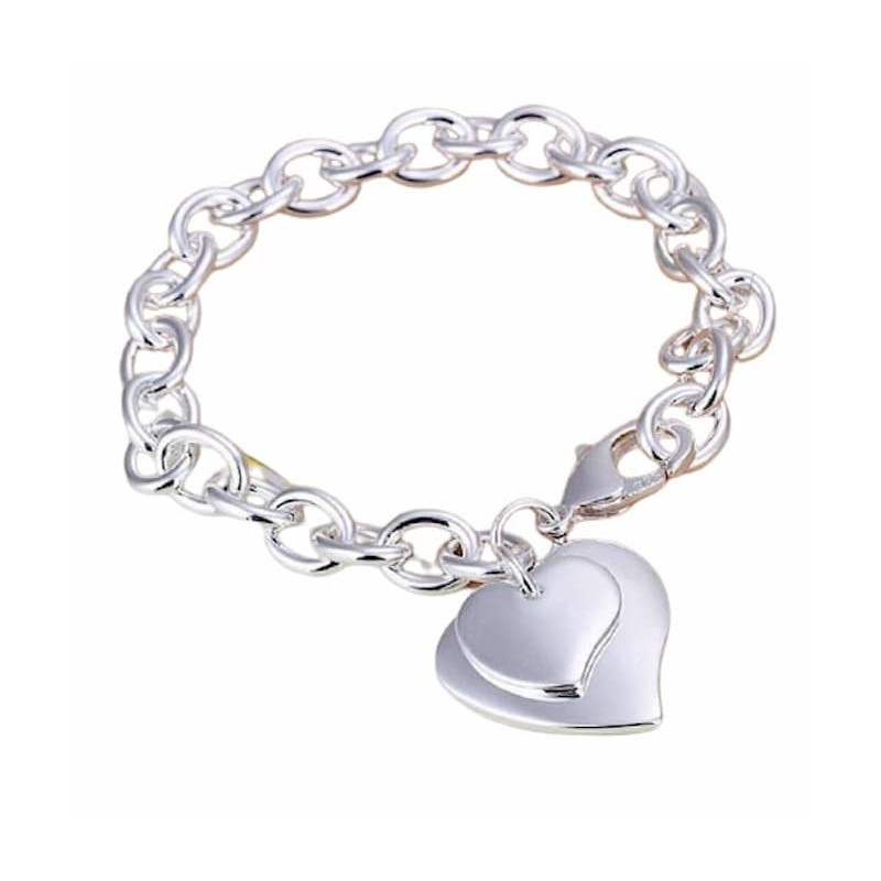 Pulsera de eslabones en acero inoxidable 316L con colgantes en forma de corazón y acabado plateado brillante.