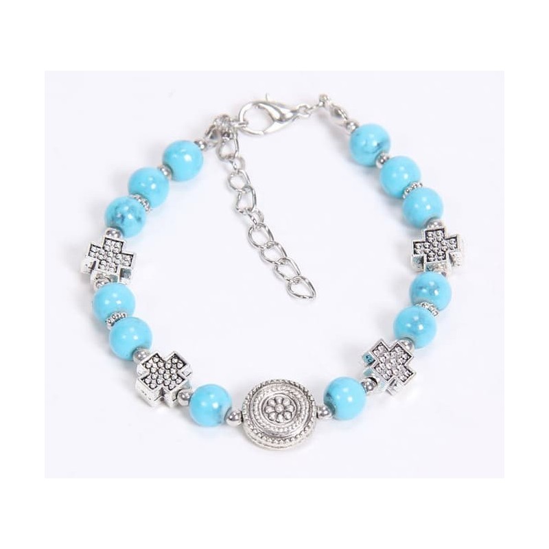 Pulsera de cadena de acero con acabado plata decorada con piedras circulares en color turquesa vibrante.