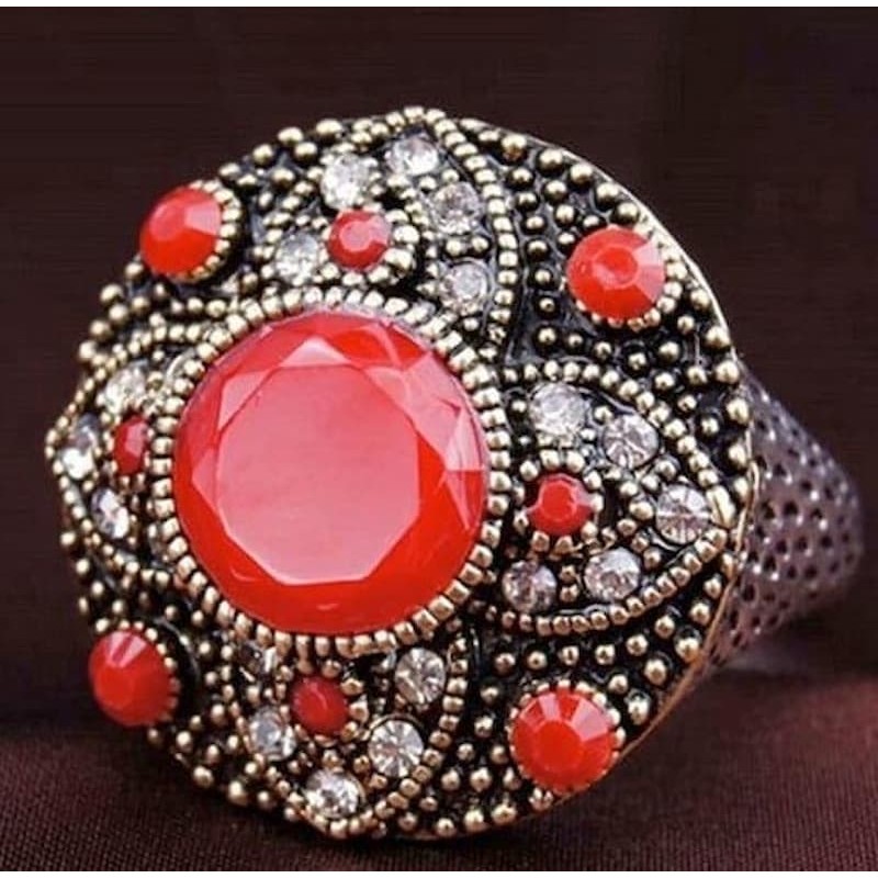 Anillo de mujer estilo vintage bañado en plata con piedra central roja facetada.