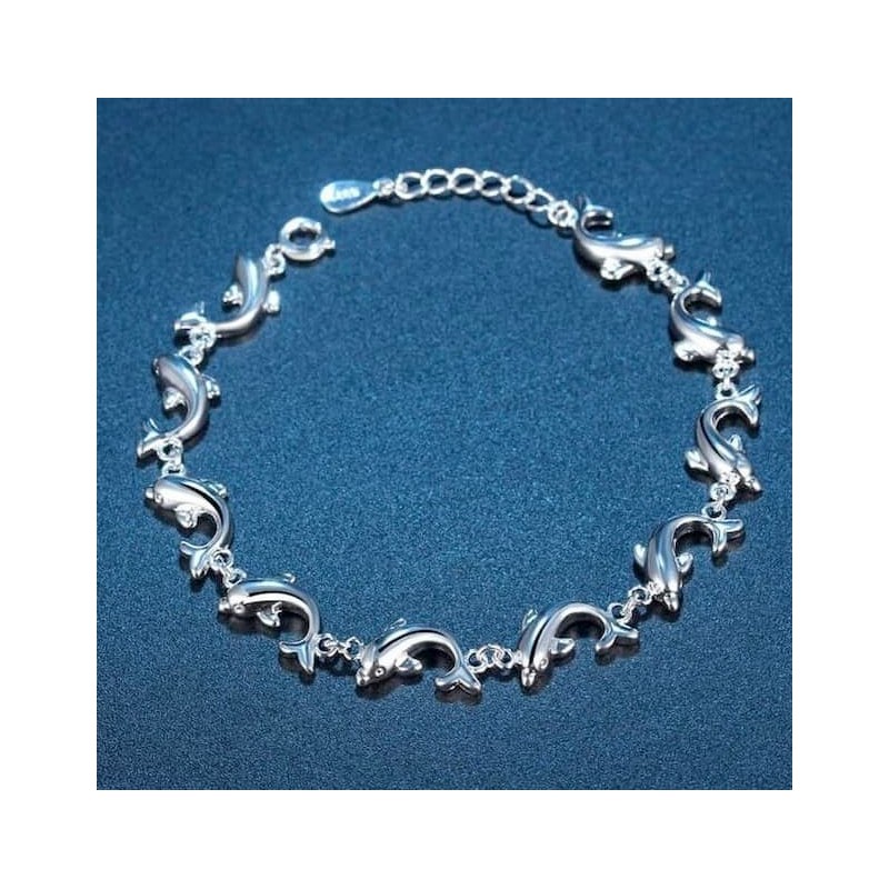Pulsera para mujer con eslabones en forma de delfines saltando, fabricada en acero con chapado brillante.