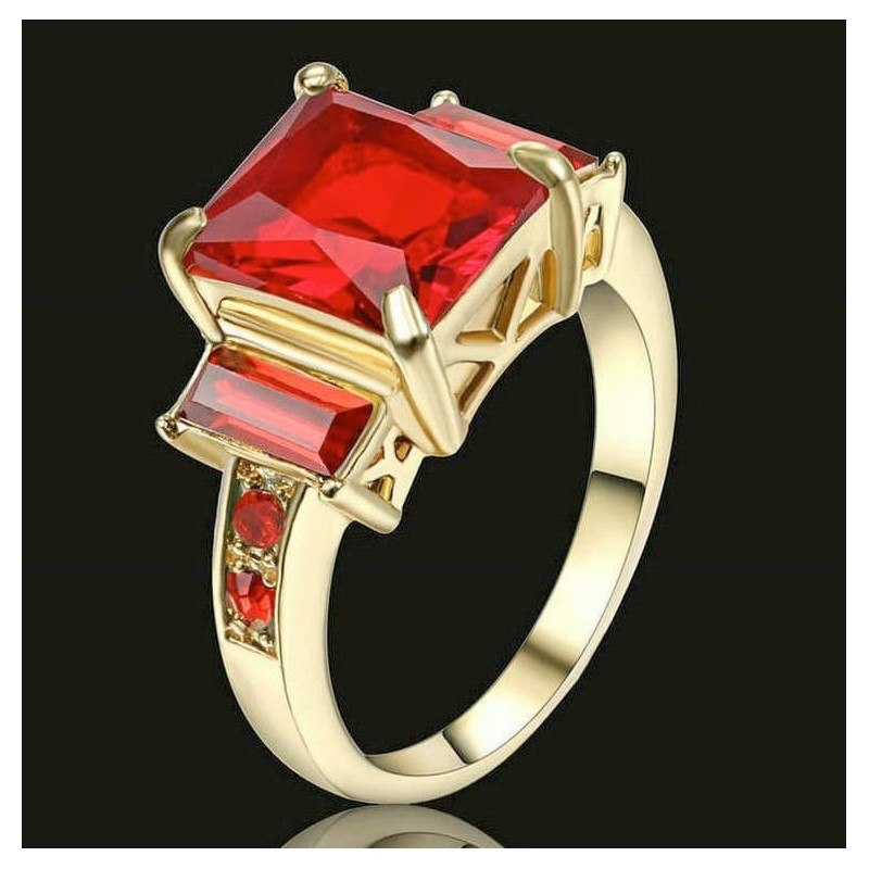 Anillo de acero con baño de oro de 14 quilates y detalles de piedras de cristal rojo brillante.