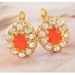 Pendientes de botón en acero con un diseño circular que alterna piedras facetadas en color rojo carmesí y blanco cristalino.
