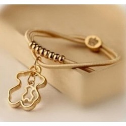 Pulsera de cordón de piel para mujer con charm central en forma de oso con acabado dorado brillante.