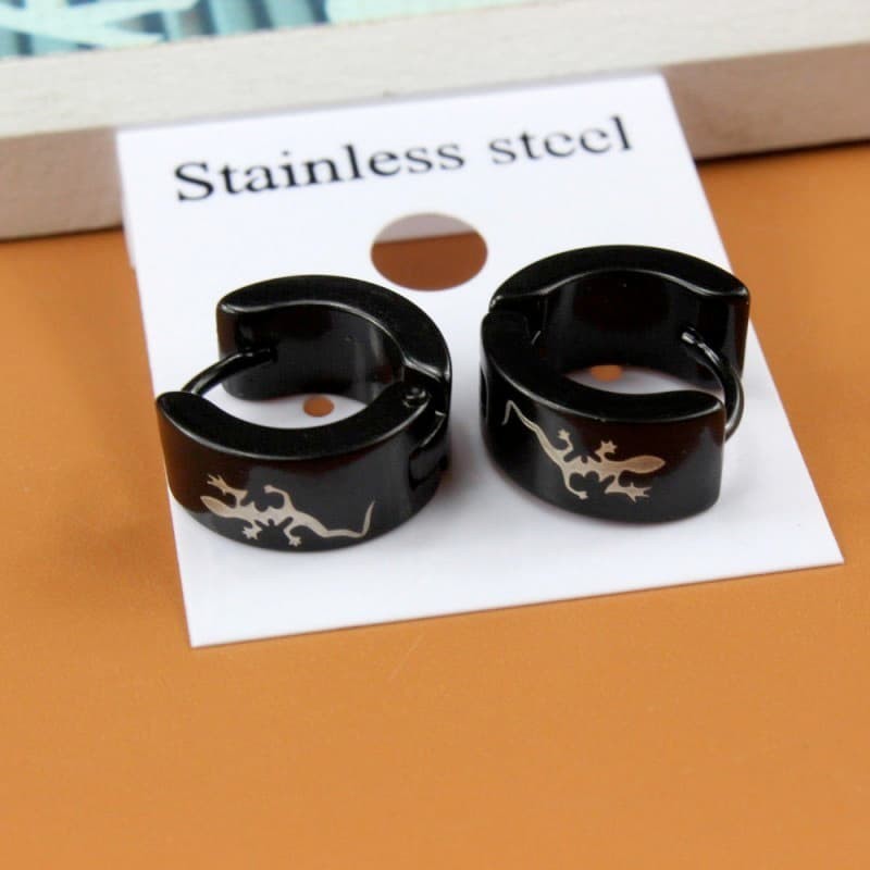 Pendientes tipo huggie en color negro mate, aros pequeños de diseño minimalista y cierre de clic.