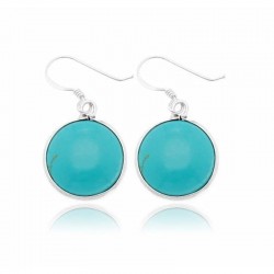 Pendientes de mujer fabricados en plata de ley 925 con una piedra turquesa natural de forma redonda y pulida.