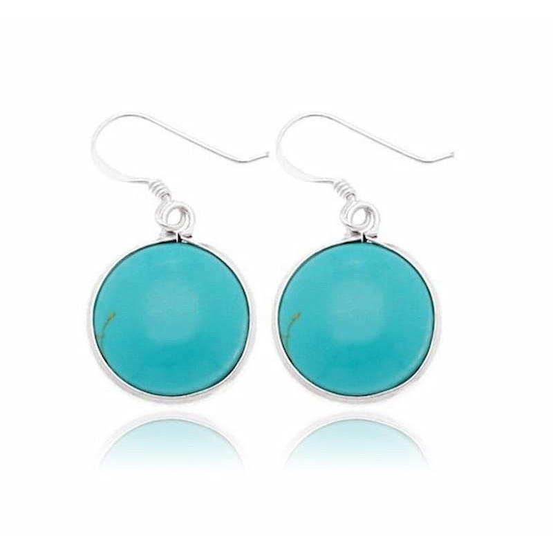 Pendientes de mujer fabricados en plata de ley 925 con una piedra turquesa natural de forma redonda y pulida.