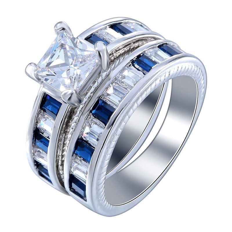 Par de anillos de acero chapado oro blanco con piedras símil zafiro en talla 17