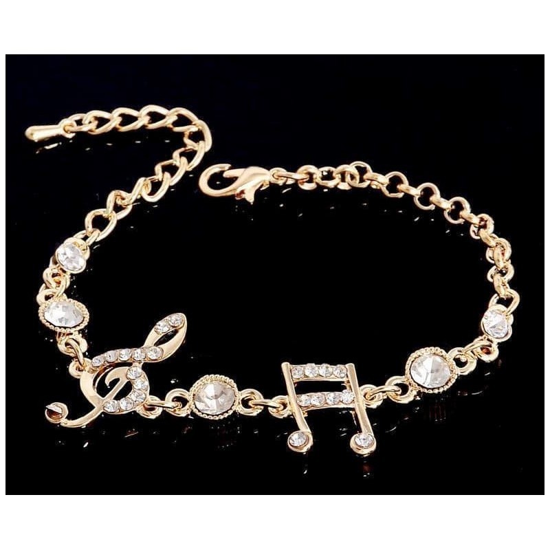Pulsera con diseño de notas musicales bañada en oro 9k y cristal