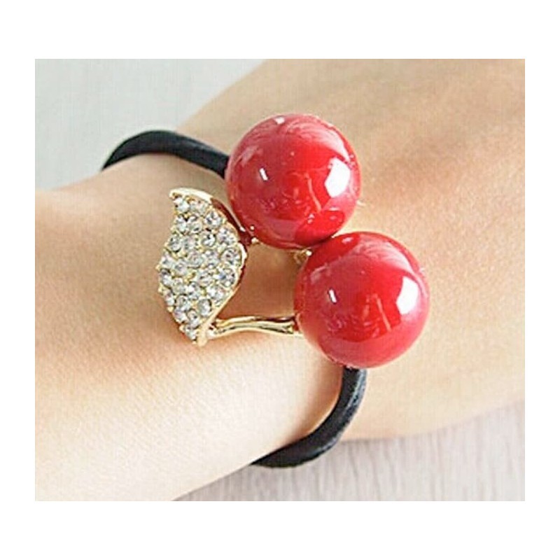 Pulsera elástica de tejido suave que también funciona como coletero o colita para el pelo, color neutro.