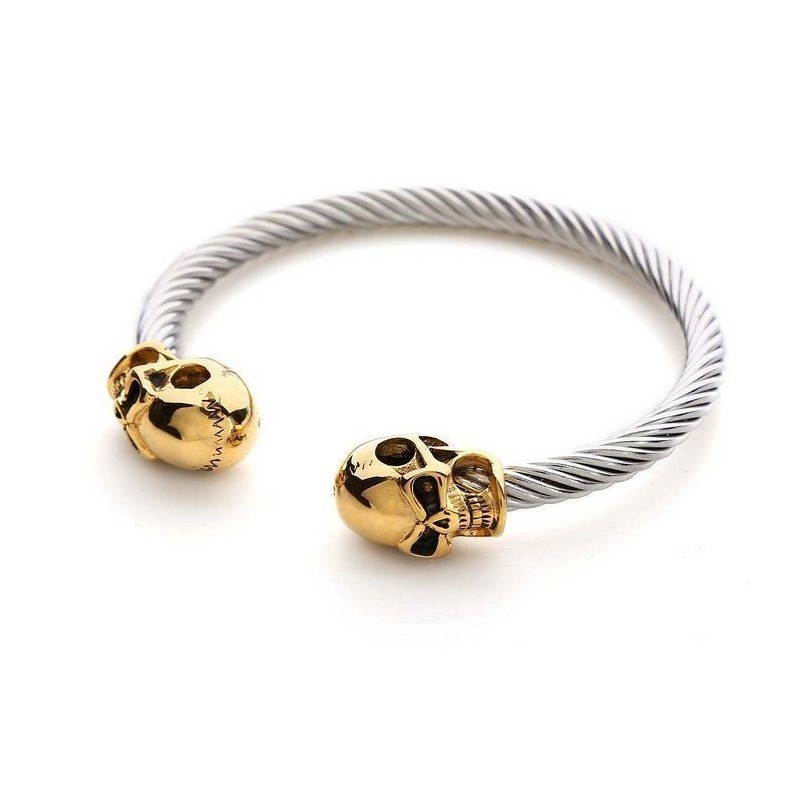 Pulsera elástica unisex con cuentas negras mate y detalle central de calavera plateada en acero.
