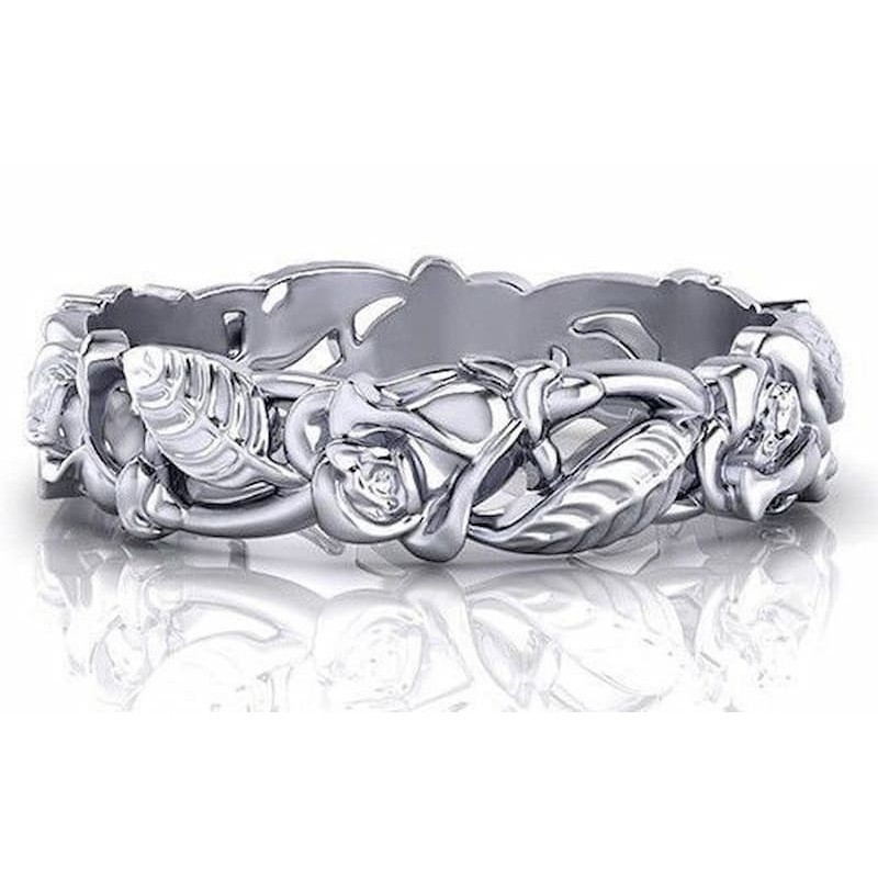 Anillo ancho de mujer con grabados de flores y hojas en relieve con acabado plata envejecida.