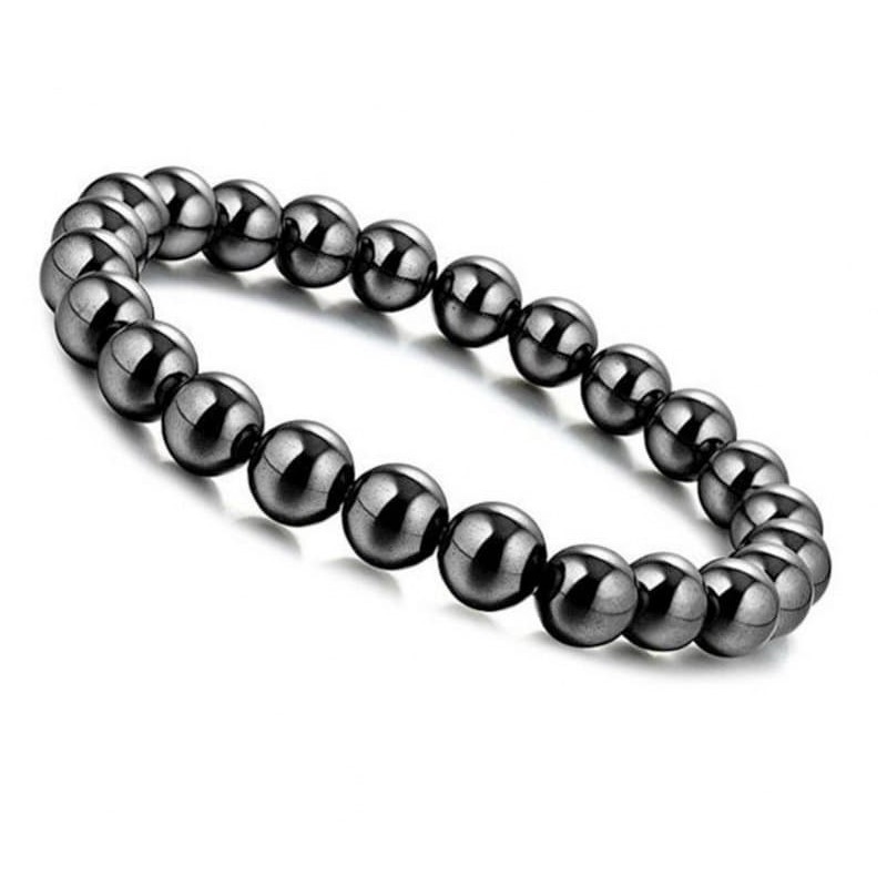 Brazalete elástico compuesto por piezas magnéticas pulidas en color oscuro con acabado brillante.