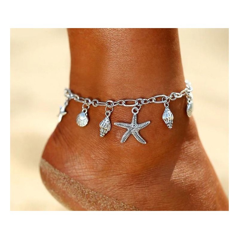 Tobillera de cadena fina de acero inoxidable con dije central de estrella de mar y acabado pulido espejo.