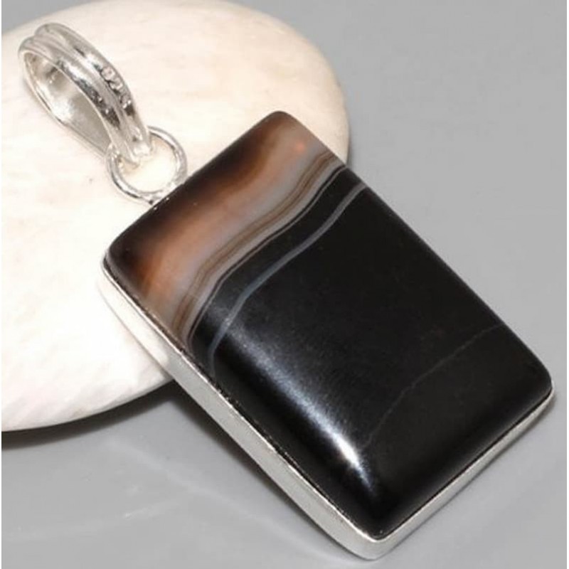 Colgante de acero con acabado plata y piedra central rectangular en color negro tipo ónix.