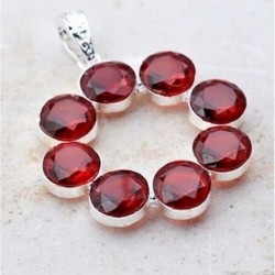 Colgante circular de acero con incrustaciones de piedras garnet de color rojo granate intenso.