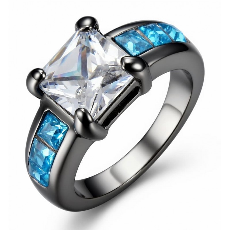Anillo de mujer adornado con una combinación de piedras blancas brillantes y piedras azules en hilera.